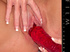 Lustful blonde vixen screwing a big red glass dildo into her cunt