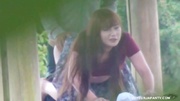 Ponytailed Asian coed in a purple T-shirt gives head and then gets banged outdoors