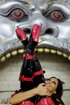 Big-titted brunette goddess in black and red latex high boots posing nude