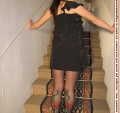 Naughty chick in sexy black dress shows hot long legs and feet in colorful