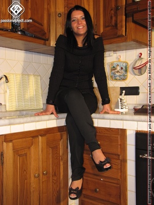 Sweet looking babe in black shows off naked charming feet in the kitchen - XXXonXXX - Pic 1