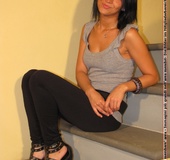 Hot girl in black pants takes off black shoes to show off cute manicured