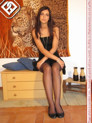 Young tall temptress in black dress, black pantyhose and shoes displays sexy feet - Picture 2