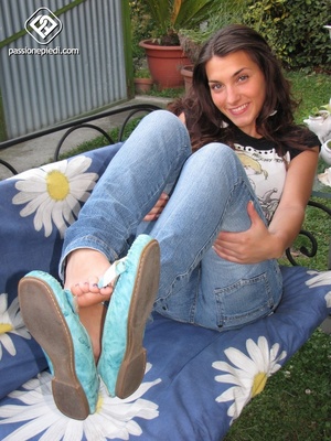 Woman takes off her blue flats to reveal her raw feet. - Picture 2