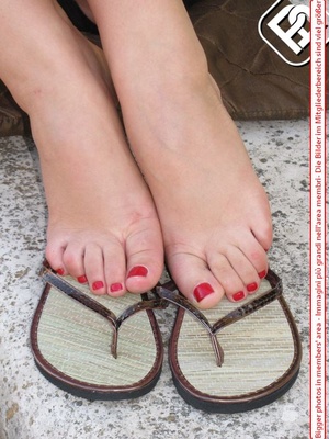 Knockout tart in flip flops displaying her yummy feet with red toe nails. - XXXonXXX - Pic 2