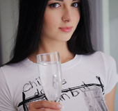 Brunette fawn in a white shirt exposes her holes at the dining table.