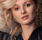 Alluring girlie in black lingerie posing naked in front of a mirror.