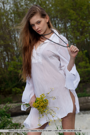 Desirable mare in a white nightgown ges naked by the water. - Picture 1