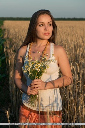 Outstanding nympho in a white shirt and orange skirt presents her trimmed pubes in a wheat field. - XXXonXXX - Pic 1