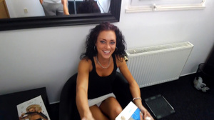 Curly brunette in black vest spreads her - Picture 1