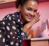 Perfect cat in a sheer polka dot top sits naked on the dining table.