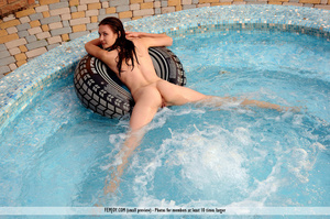 Enticing naked lady poses with an inner tube at the pool. - Picture 7