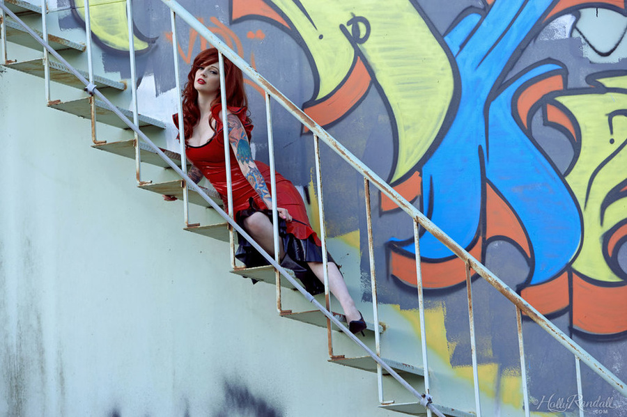 Hot tattooed redhead in red shows tasty tits and shaved pussy on steel staircase - XXXonXXX - Pic 1