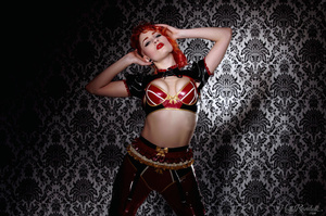 Wild and sexy redhead in spicy red and black latex outfit models her hot body - Picture 1