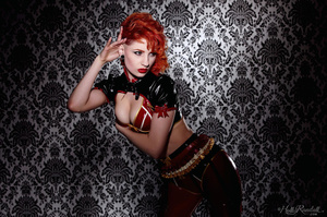 Wild and sexy redhead in spicy red and black latex outfit models her hot body - Picture 2