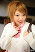 Youngster in a cardigan and white stockings posing on a desk.