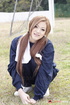 Long-haired honey poses in her blue sweats in the field.