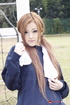 Long-haired honey poses in her blue sweats in the field.
