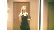 Heavenly darling in a black dress flashing her goodies in front of a mirror.