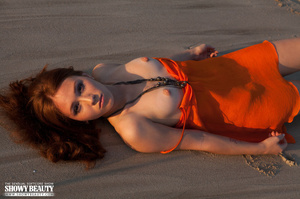 Glamorous belle in an orange dress shows her crack at the beach. - Picture 7