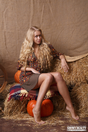Beaver in a colorful dress posing on some hay in the studio. - XXXonXXX - Pic 1