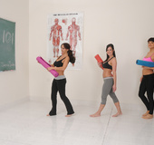 Three hot chicks lays down their mats with different colors and performs