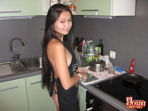 Asian in black apron slicing veggies gets it on with thong pulled to the side by eager lover. - Picture 2