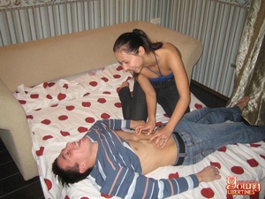 Girl in jeans and a blue top tickles a guy on pullout before treating his cock to a pussy feast. - Picture 4