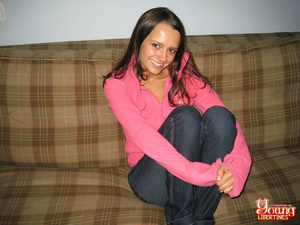 Sexy coed in jeans and a pink sweatshirt strips to reveal striped thong before touching her clit. - Picture 2
