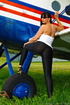 Aviation buff parades her generous chest when standing by an airplane