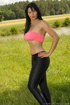 Horny MILF in a grassy area wears a hot pink tube top and painted-on revealing