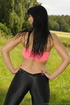 Horny MILF in a grassy area wears a hot pink tube top and painted-on revealing