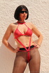 Outdoor shots of a gal in sunglasses, black stockings and red bondage-friendly