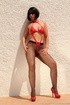 Outdoor shots of a gal in sunglasses, black stockings and red bondage-friendly