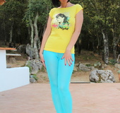 Filly with a brunette bob haircut in a yellow graphic tee reaches into