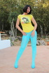 Filly with a brunette bob haircut in a yellow graphic tee reaches into