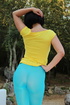 Filly with a brunette bob haircut in a yellow graphic tee reaches into