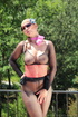 Woman leaning over a balcony has on black nylons with the ass cut out