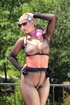 Woman leaning over a balcony has on black nylons with the ass cut out