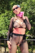 Woman leaning over a balcony has on black nylons with the ass cut out