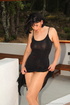 Brunette in red pumps wearing panty hose and slinky black dress plays