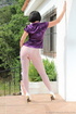 Lady unbuttons purple satin top and reaches into white nylons to pay attention