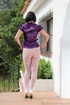 Lady unbuttons purple satin top and reaches into white nylons to pay attention