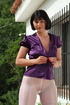 Lady unbuttons purple satin top and reaches into white nylons to pay attention