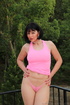Pink racer-back tank pulled up to show tits on girl who spreads her legs