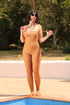 Full-body support hose is rolled down the chest of a whore who just stepped