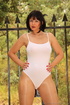 Black leg warmers stay on babe by black fence as she pulls her nude nylons