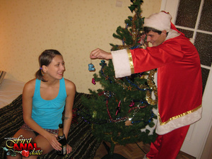Captivating madam in a plaid skirt and black panties gets some anal near the christmas tree. - Picture 2