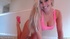 Naughty blonde in seductive pink top and panties plays with red dildo