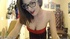 Busty brunette whore in glasses and sexy dress whipping her intimate places